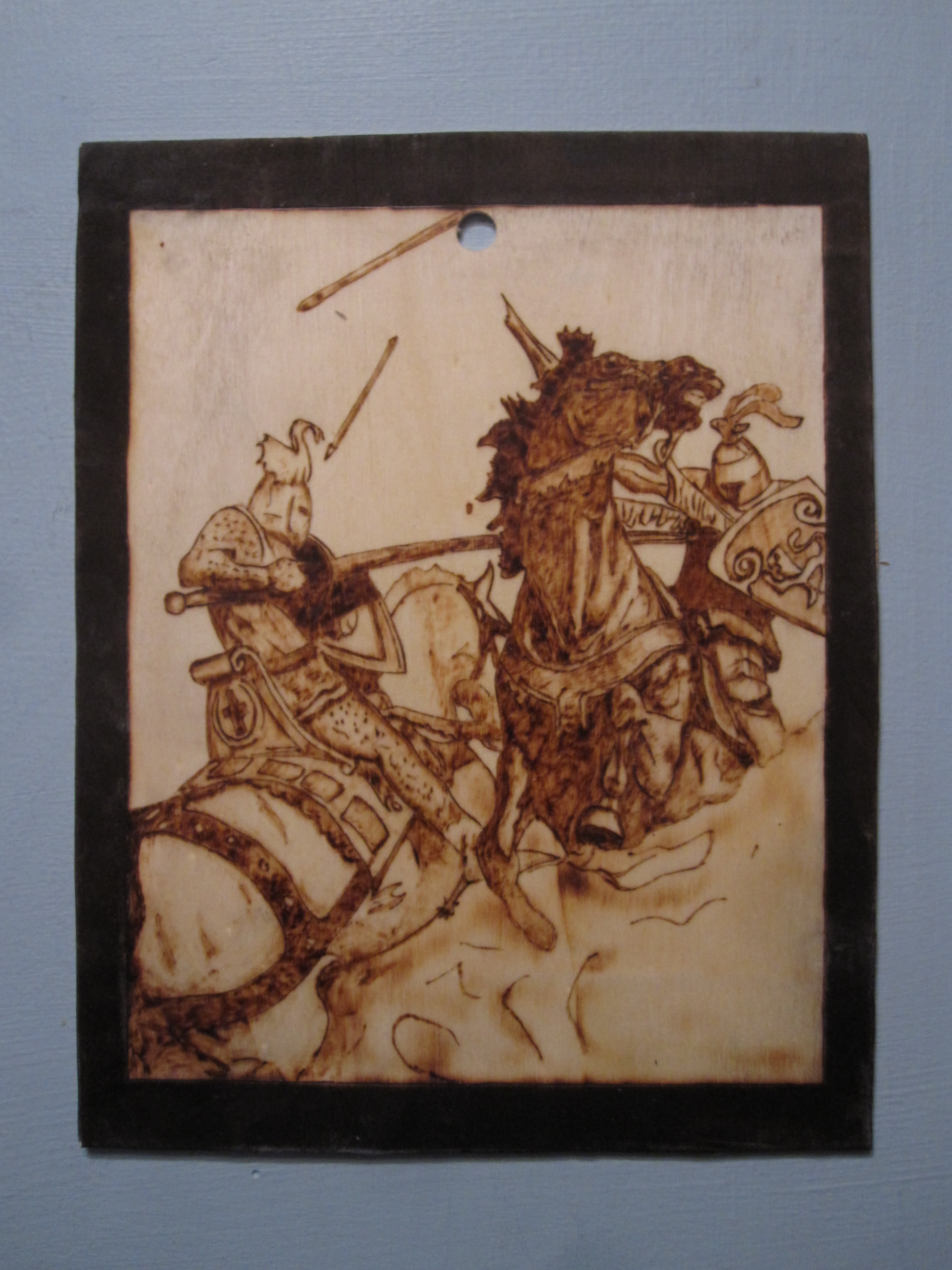 The Joust woodburned wallhanging