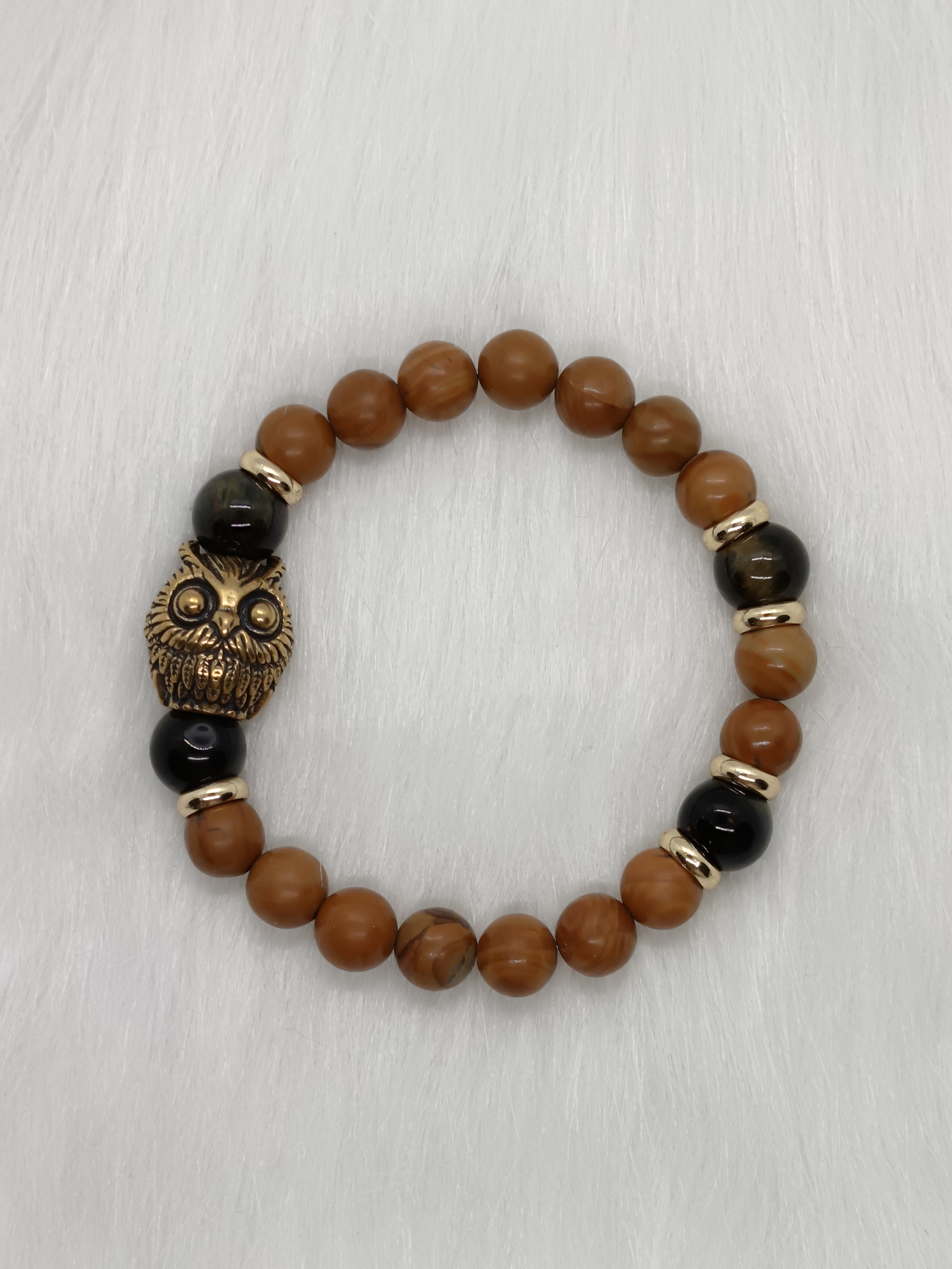 Bracelet "hibou" en bois fossilisé et œil de faucon 