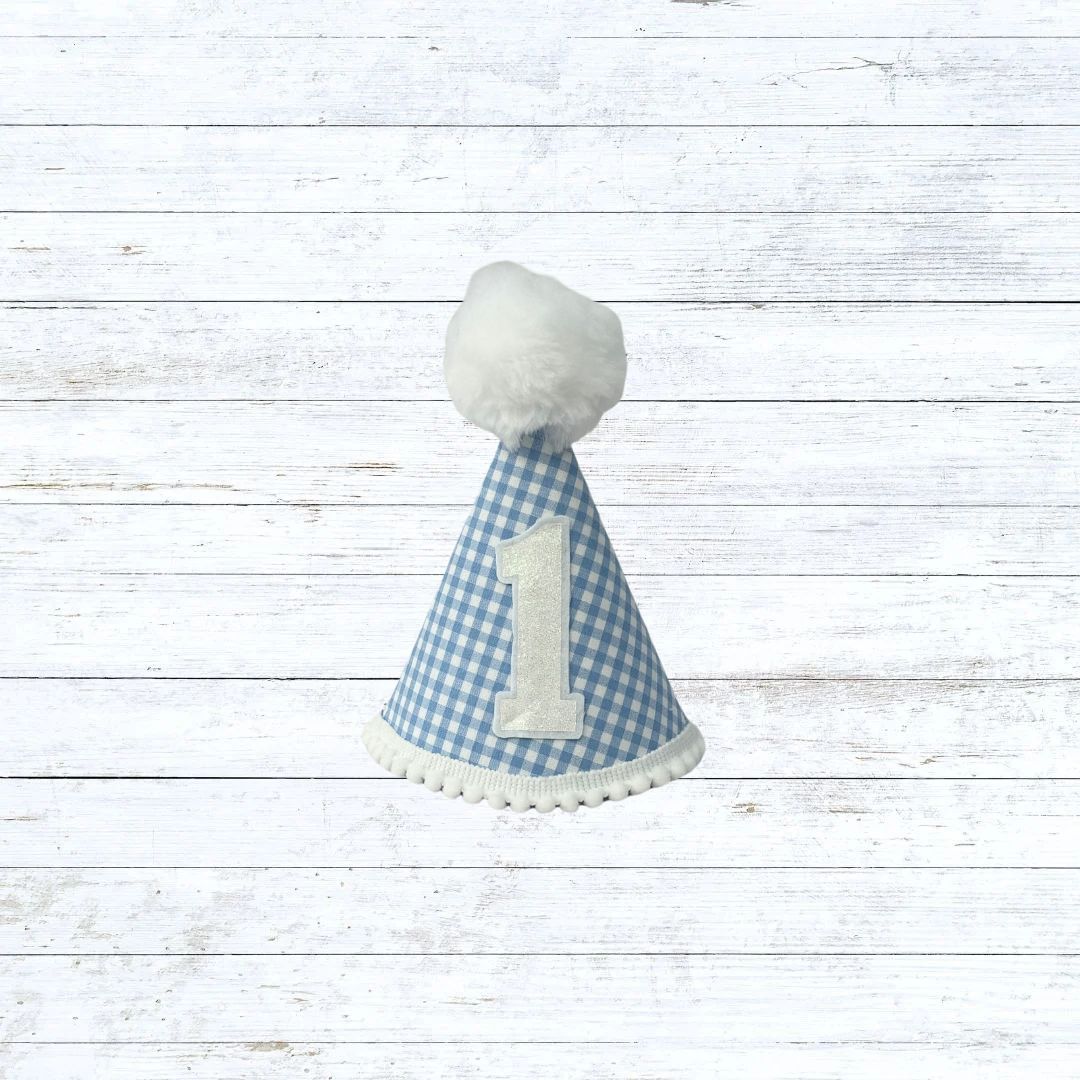 Light blue gingham child's party hat with white trims and pom pom