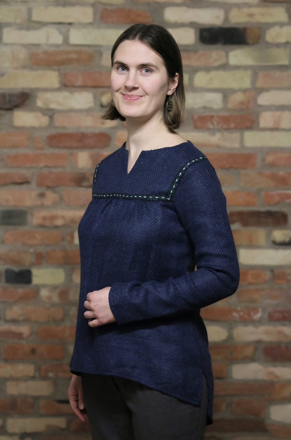 Thin woolen shirt with a woven decorative band
