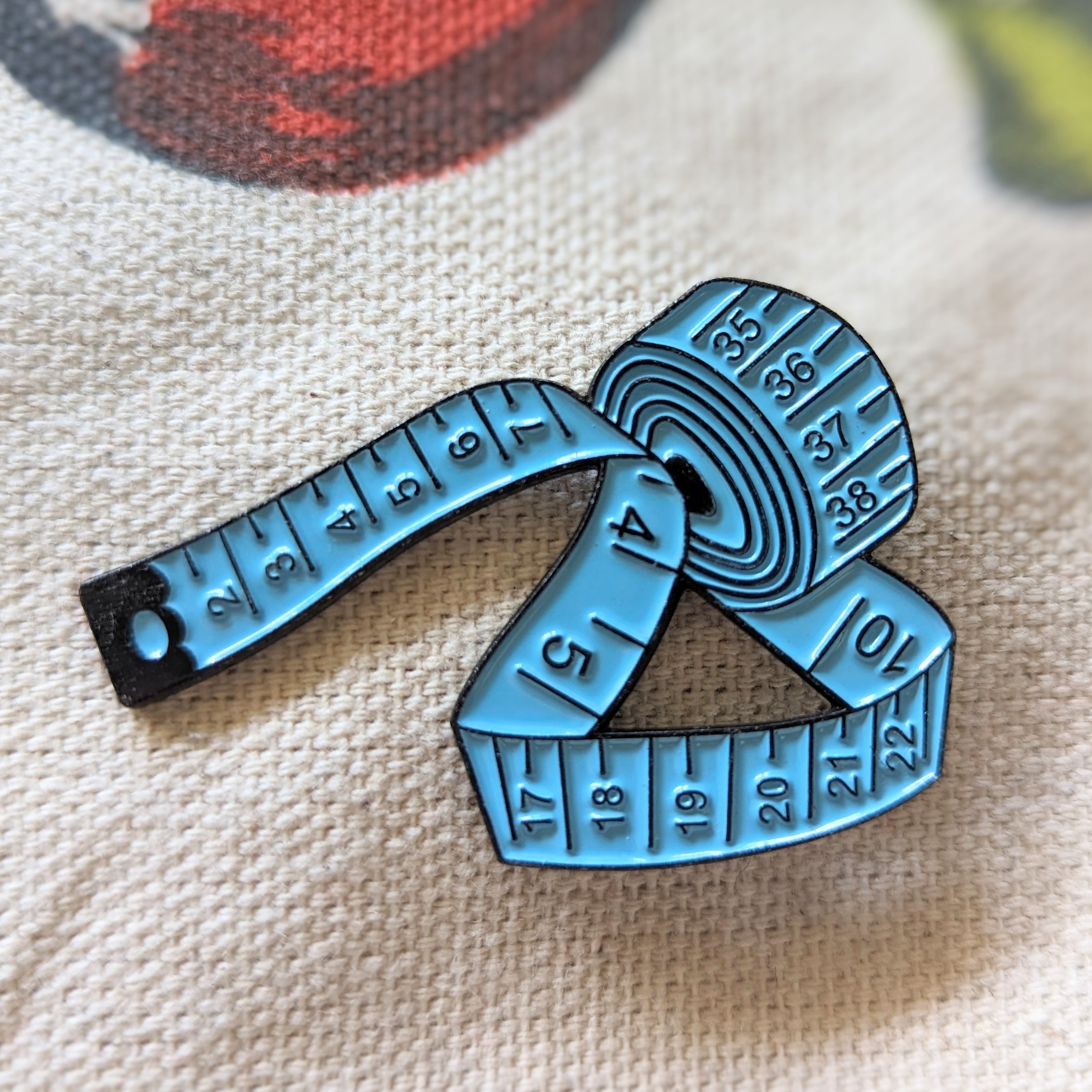 Pin de cinta métrica