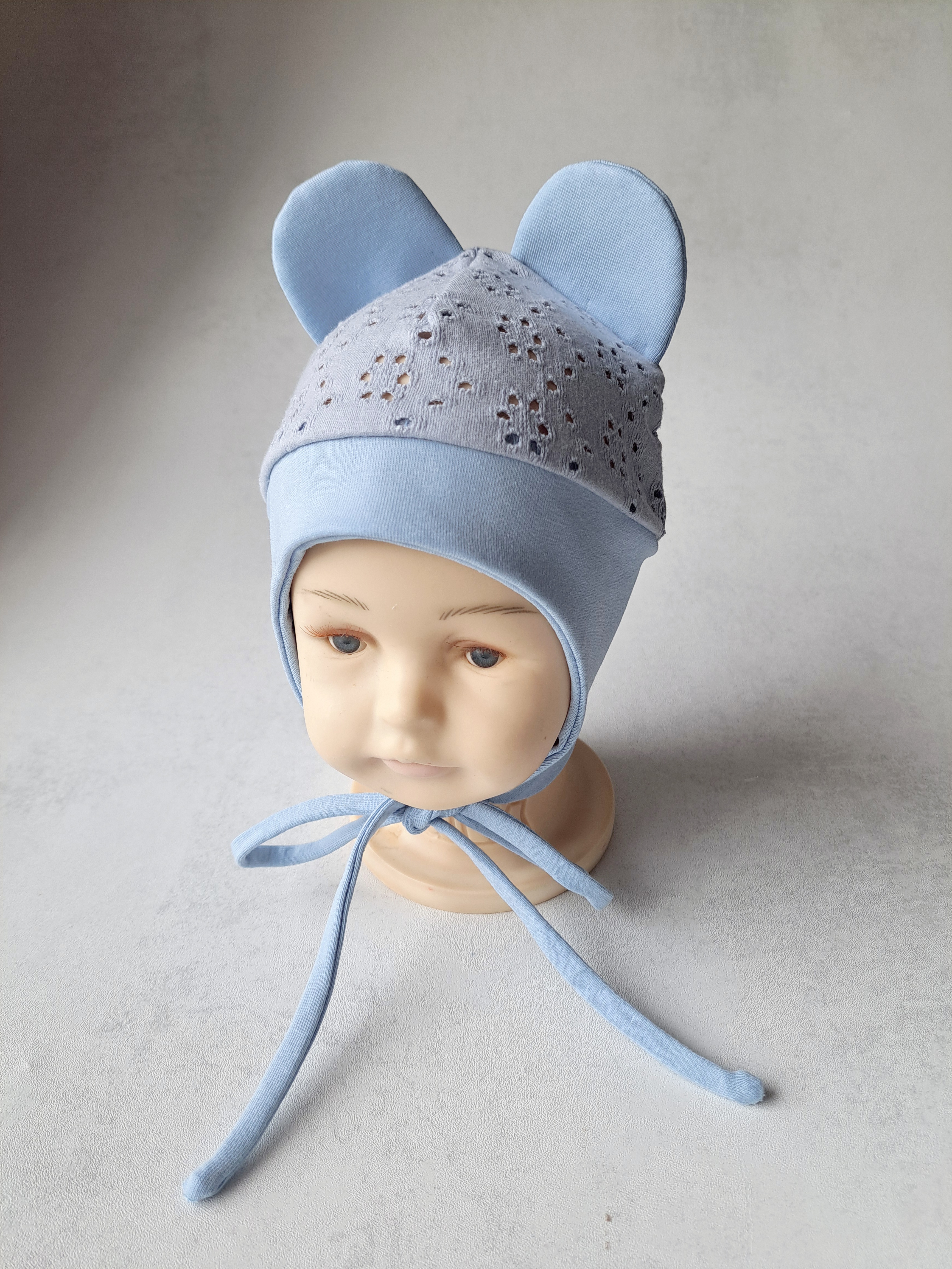 Žydros spalvos kepurė su raišteliais