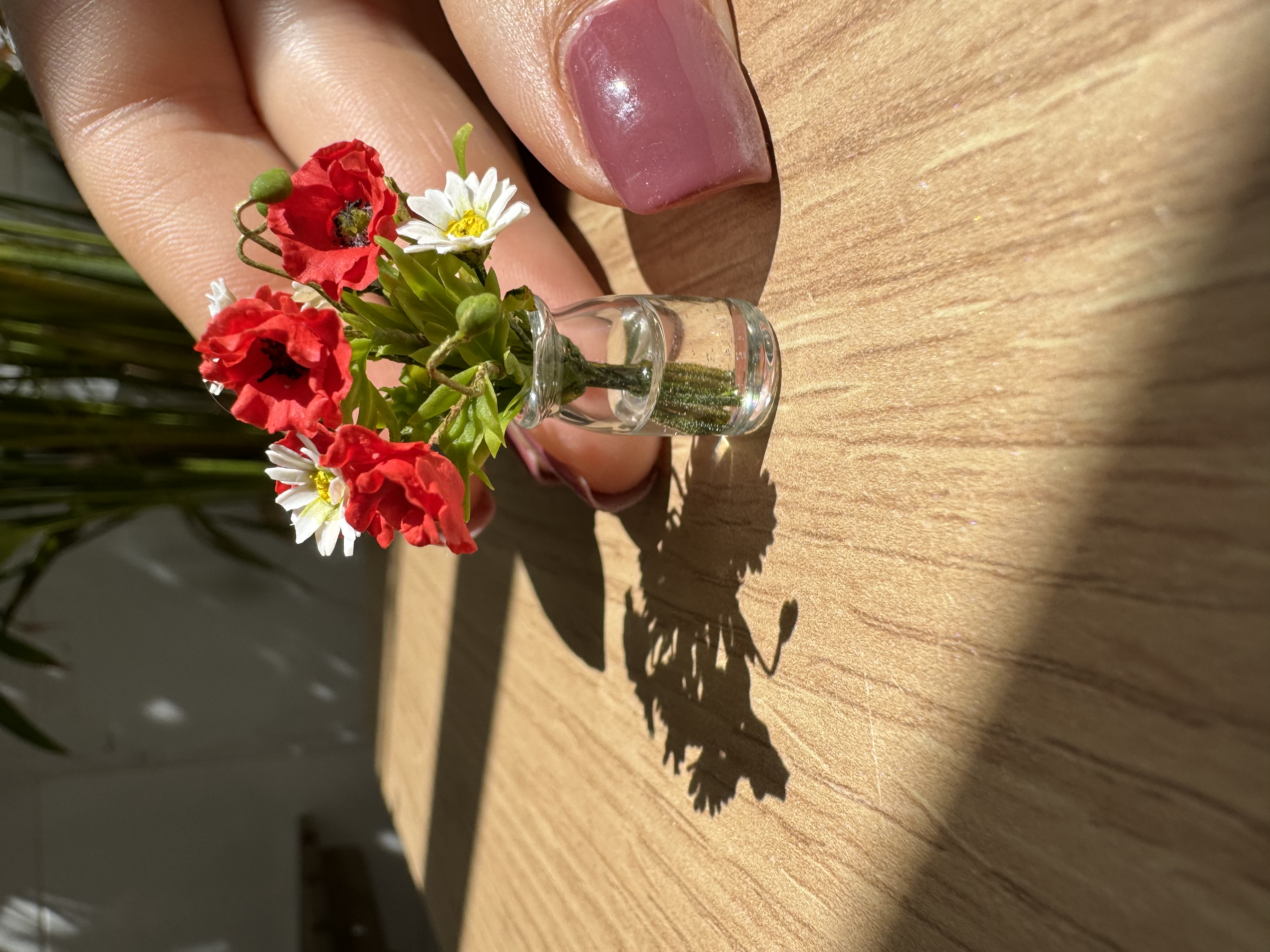 Poppies and daisies in glass vase
