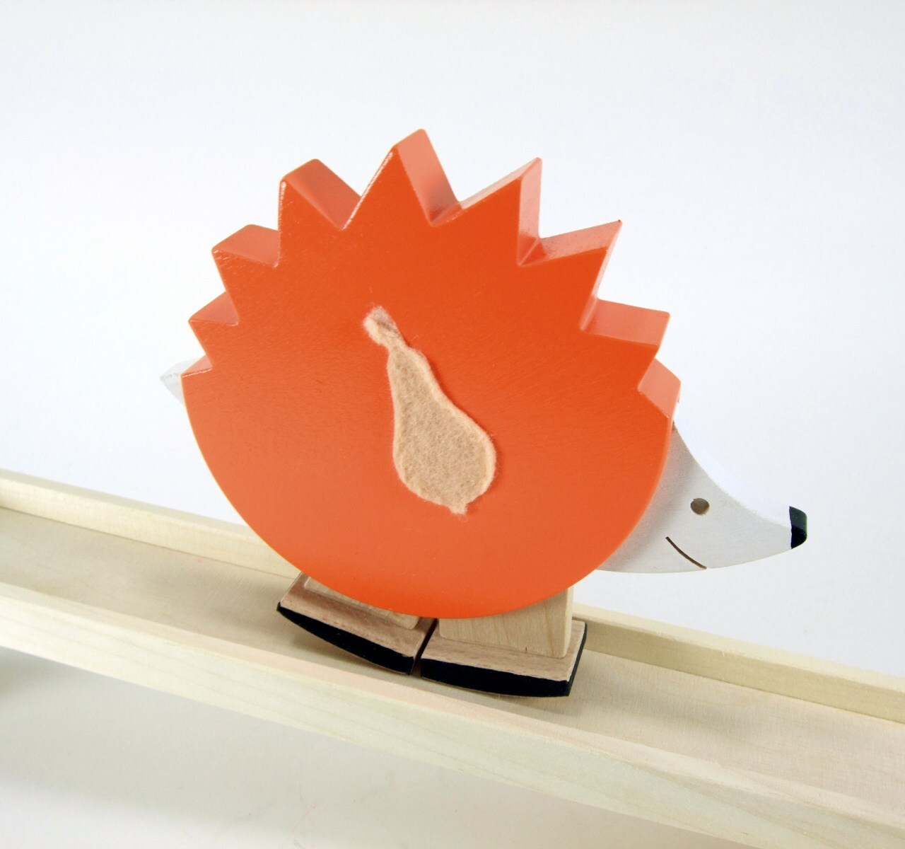 Ežiukas vaikštantis ant medinio takelio