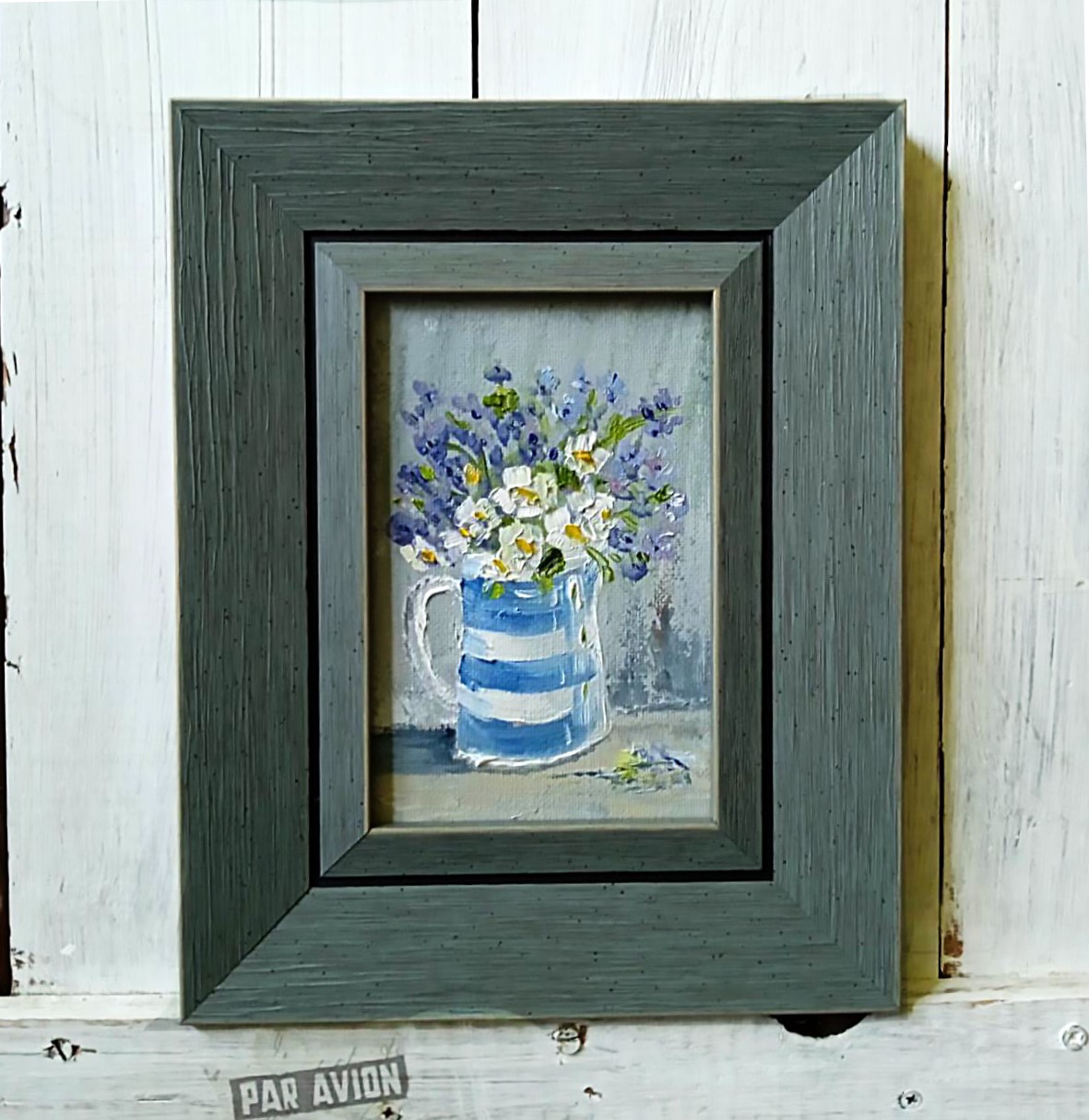 White flowers in a striped vase.