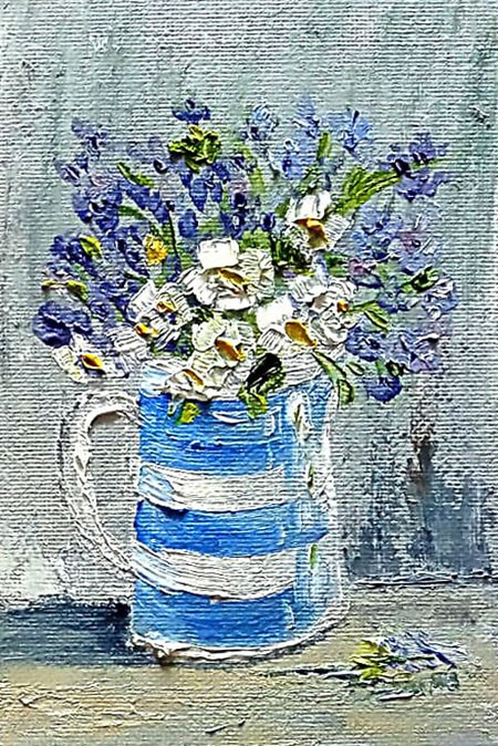 White flowers in a striped vase.