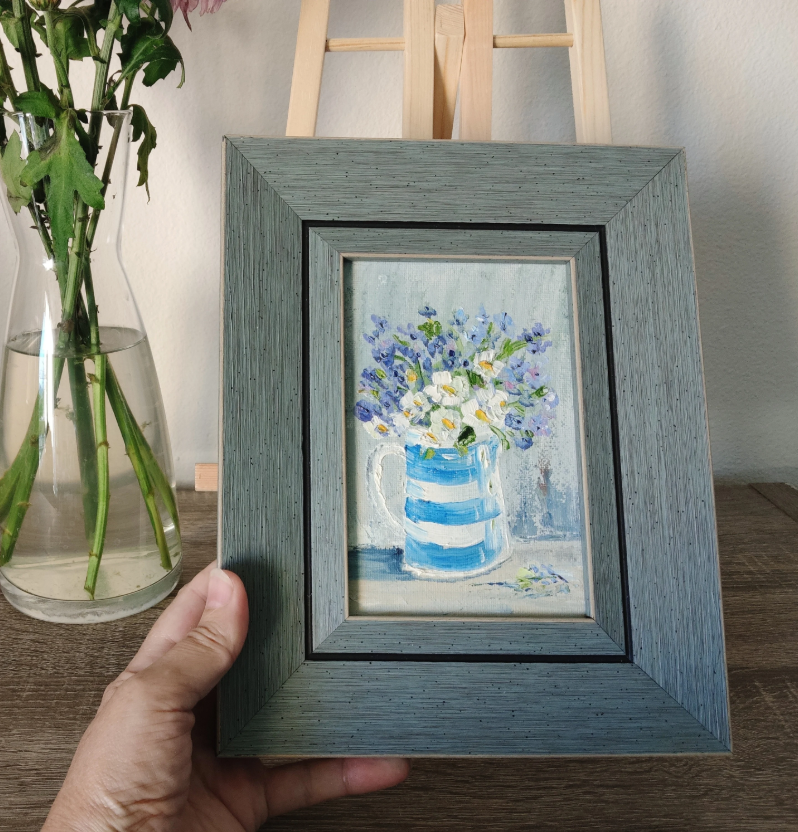 White flowers in a striped vase.