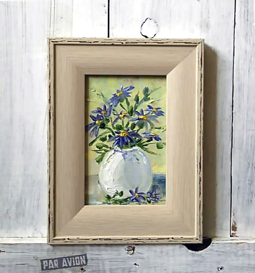 Blue flowers in a white vase.