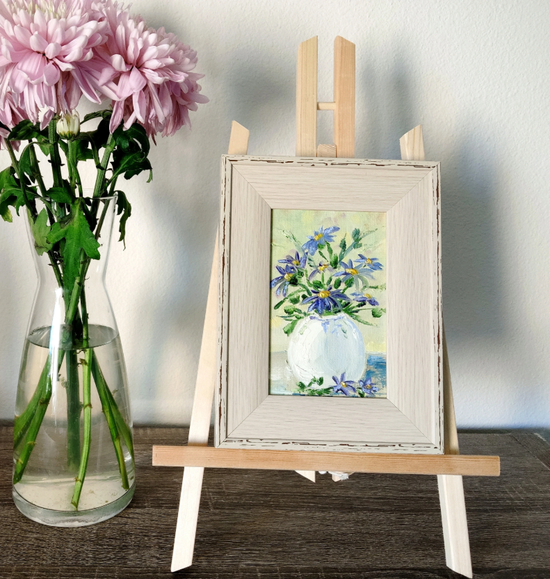 Blue flowers in a white vase.