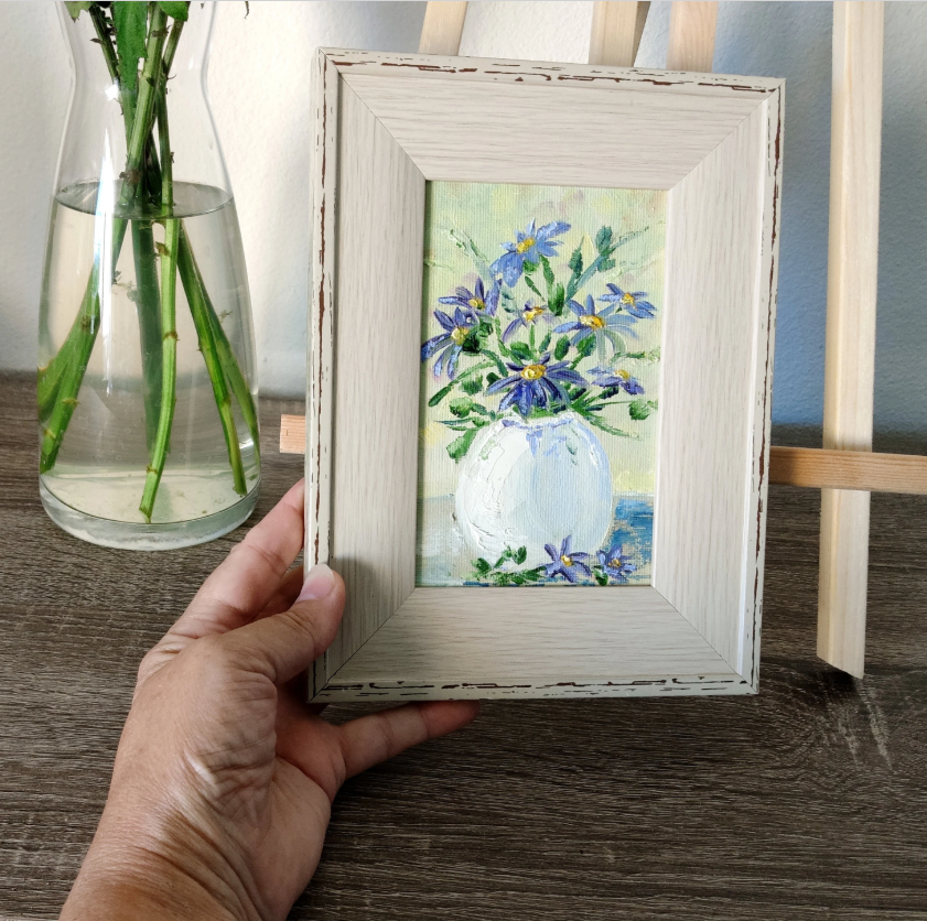 Blue flowers in a white vase.