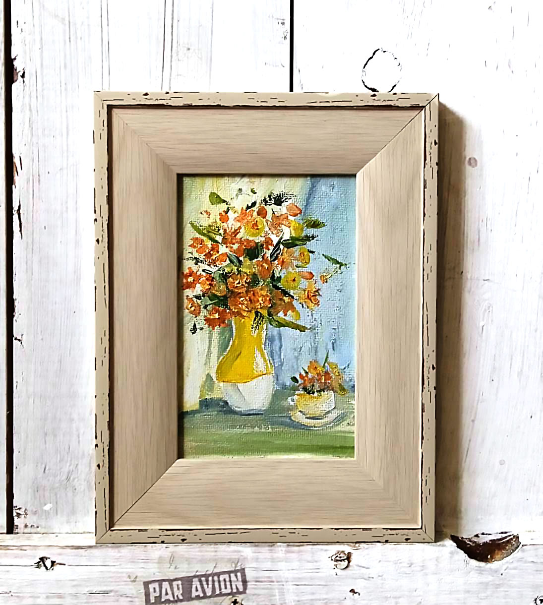 Orange flowers in a yellow vase.