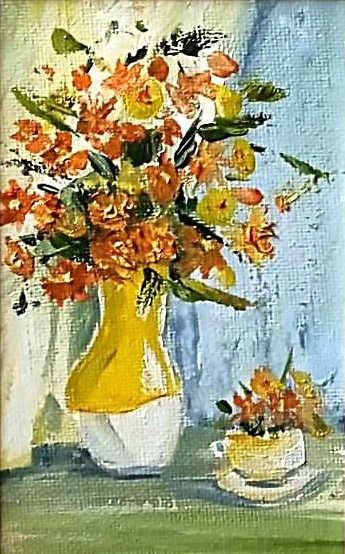 Orange flowers in a yellow vase.
