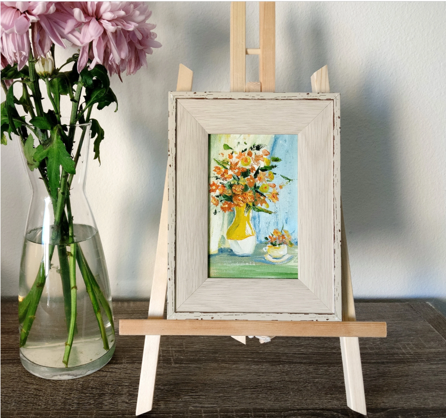 Orange flowers in a yellow vase.