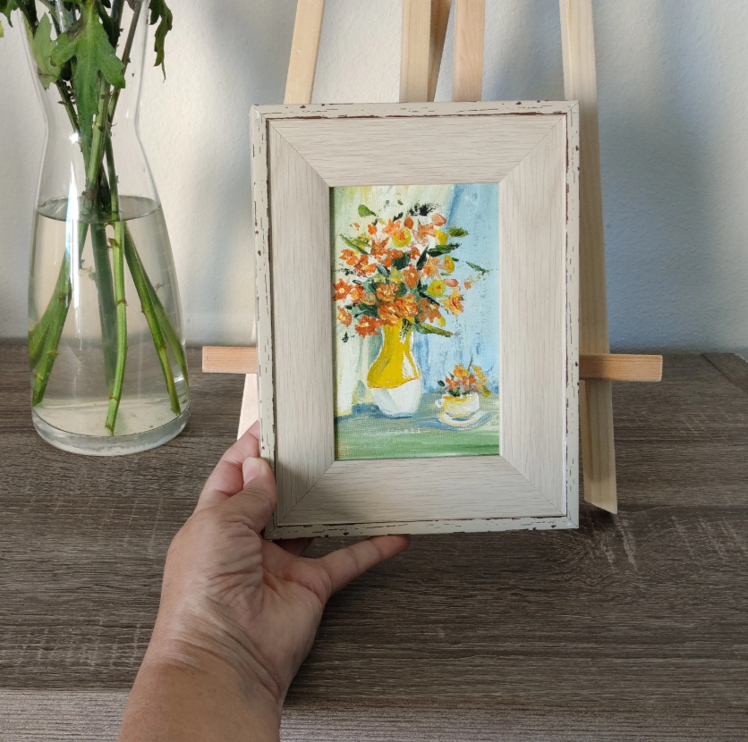 Orange flowers in a yellow vase.