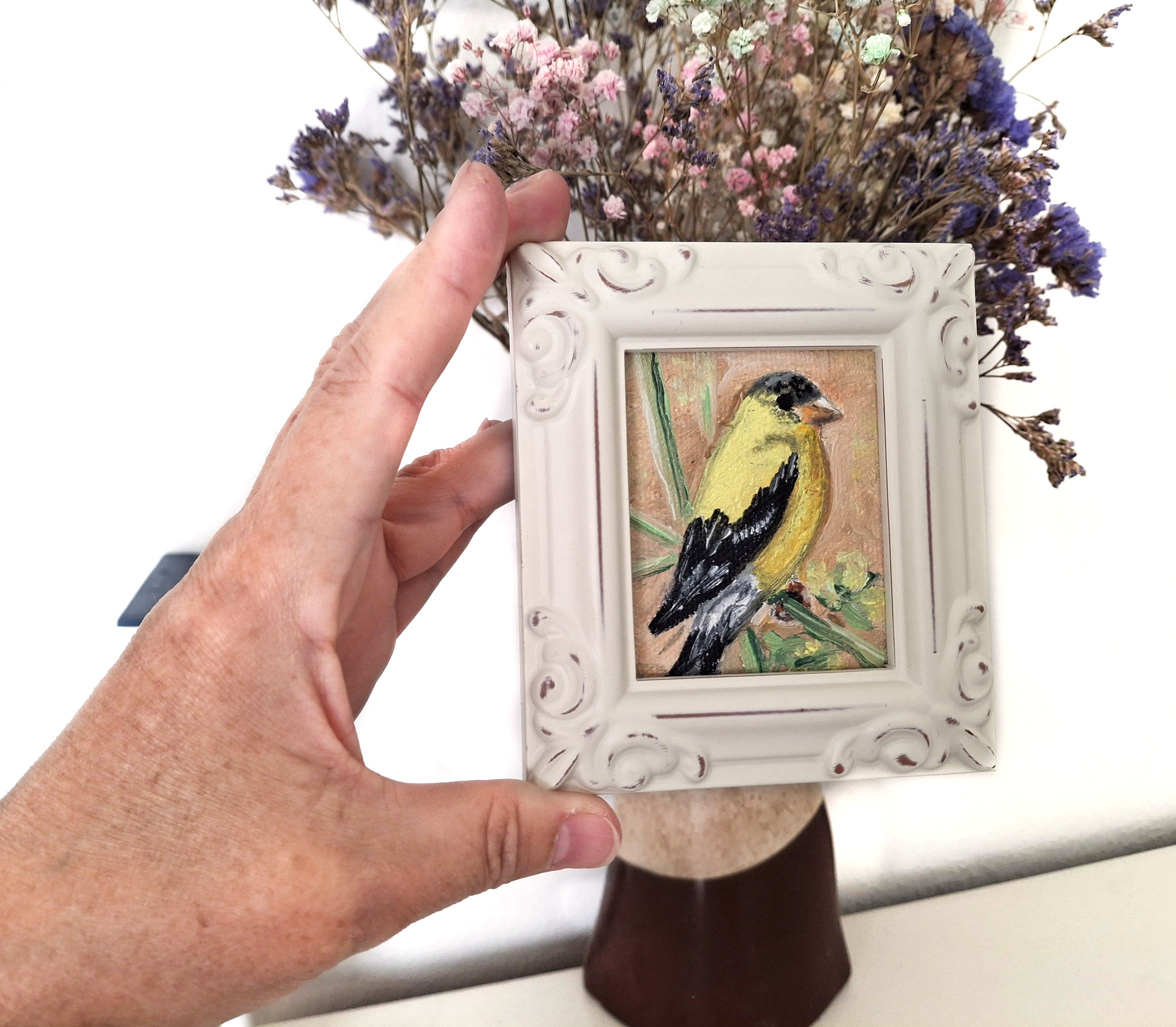 Yellow bird in vintage frame