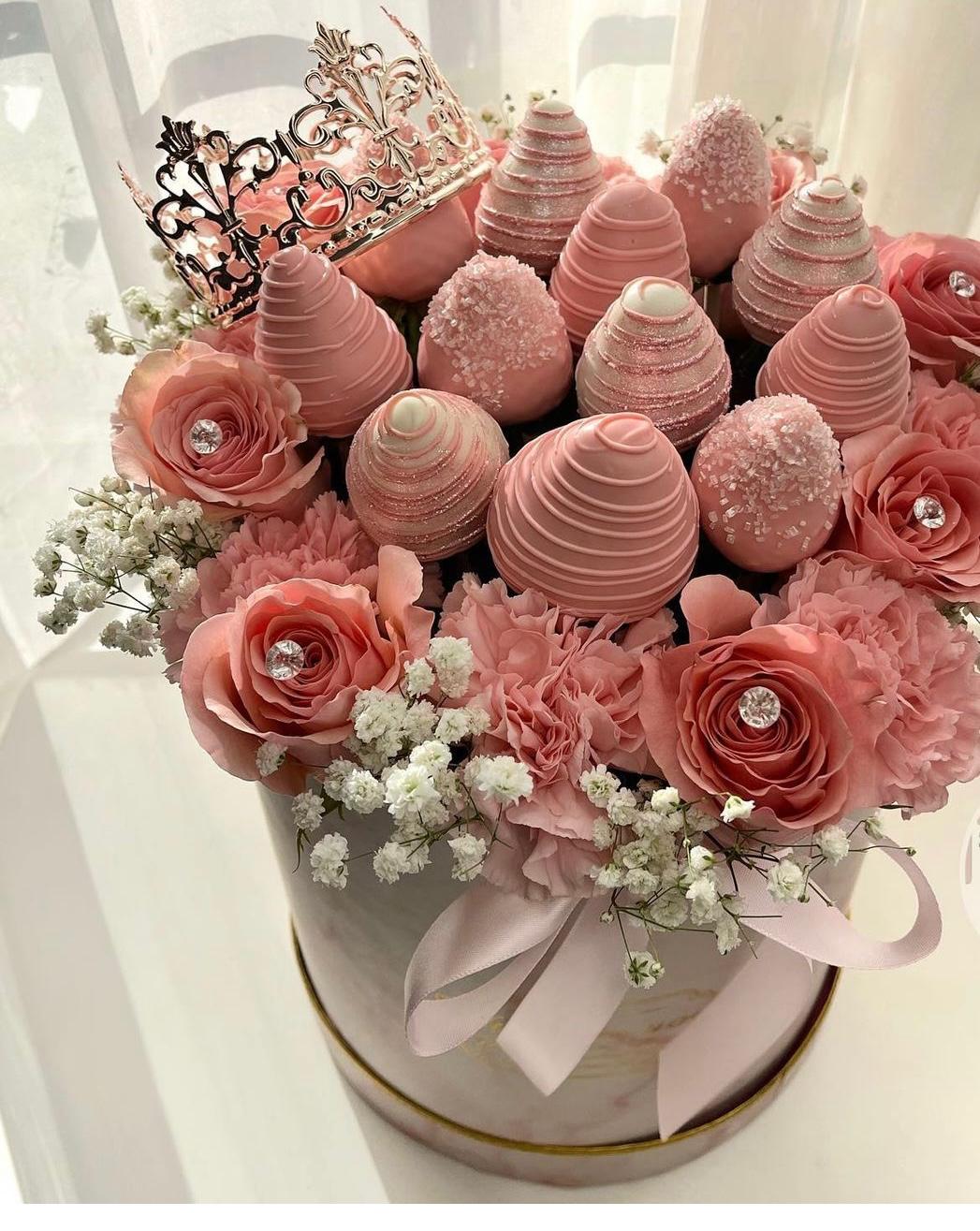 Elegant strawberry floral arrangement with 12 Roses and 12 covered strawberries .