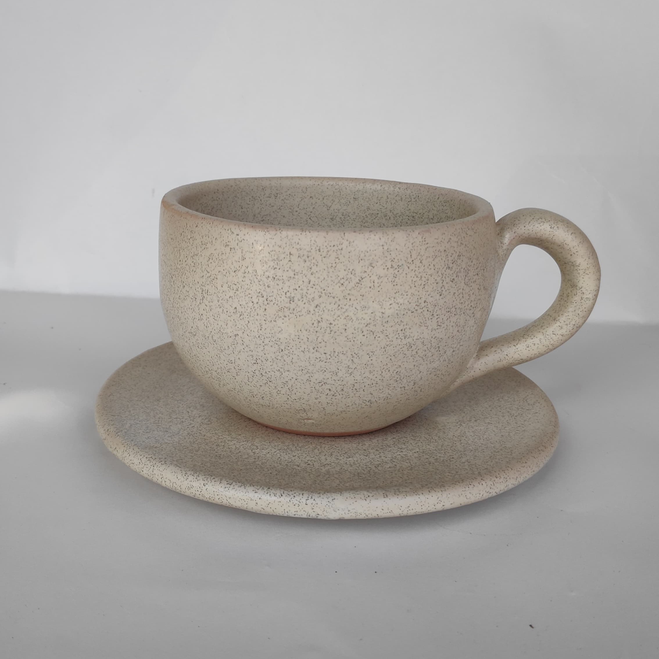 Ceramic coffee cup with matching saucer