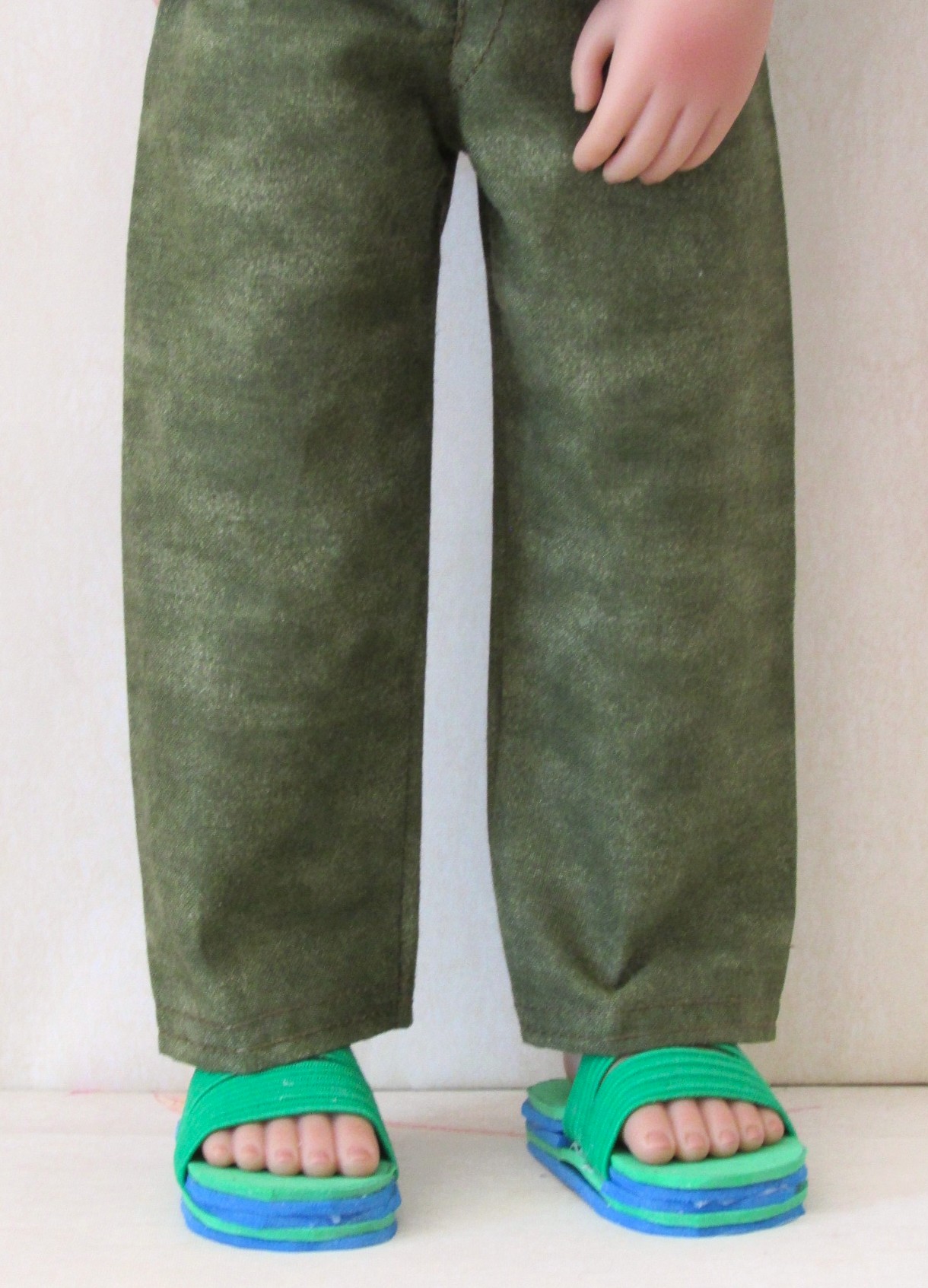 881   Surfing Tee-Shirt, Olive Green Jeans, Green & Blue Sliders, Black Sunglasses