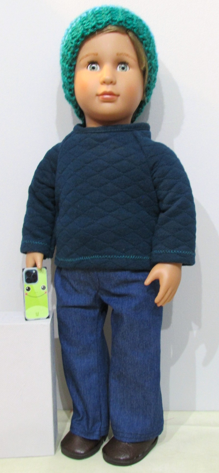 842    Deep Petrol Top, Knitted Hat, Blue Jeans, Brown Shoes and Mobile Phone
