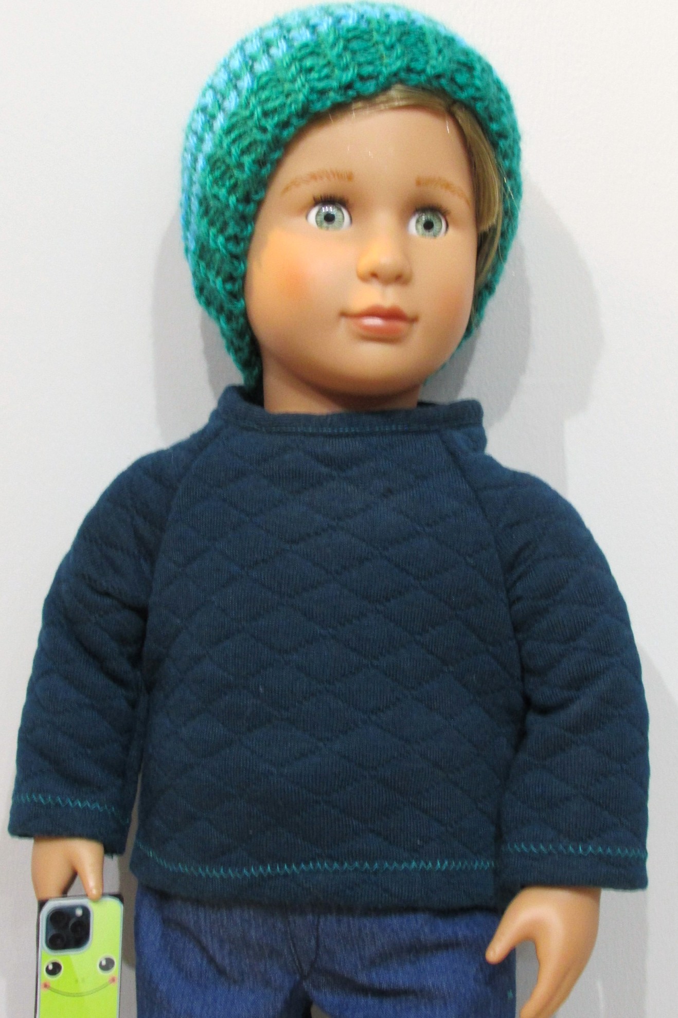 842    Deep Petrol Top, Knitted Hat, Blue Jeans, Brown Shoes and Mobile Phone