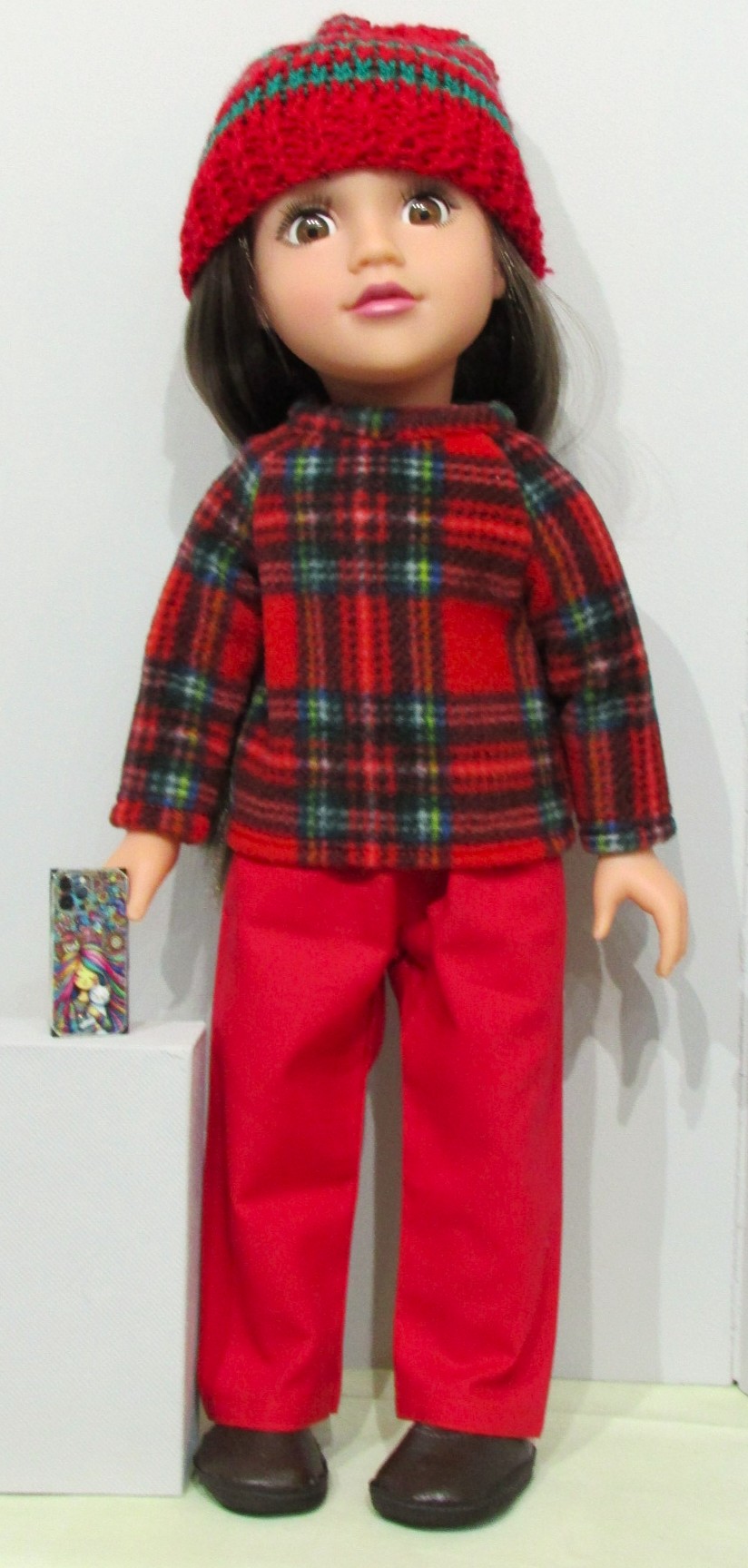 837    Tartan Fleece Top, Hat, Red Jeans, Shoes and mobile phone