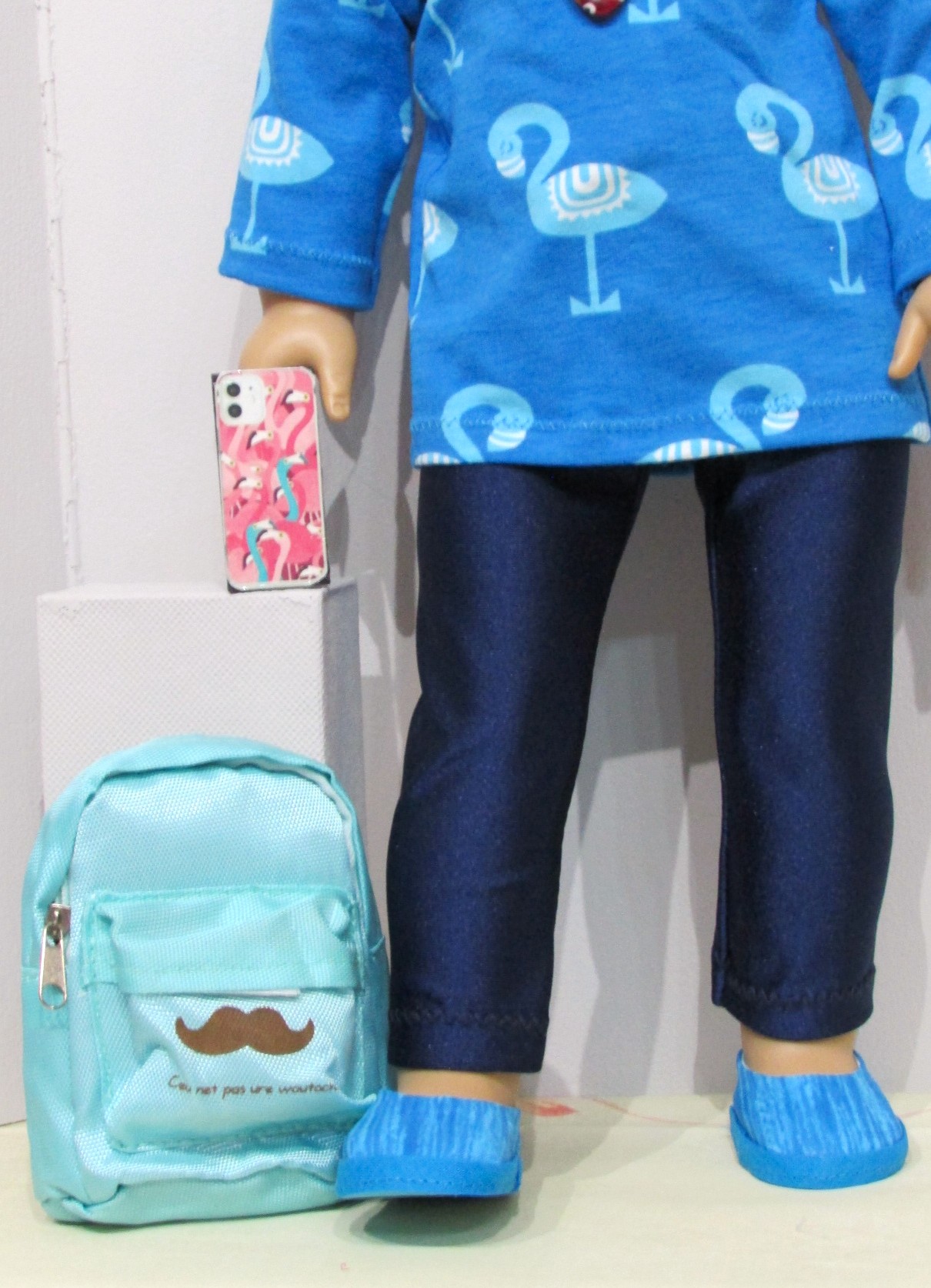 832   Flamingo top, navy blue leggings, shoes, necklace, mobile phone & rucksack