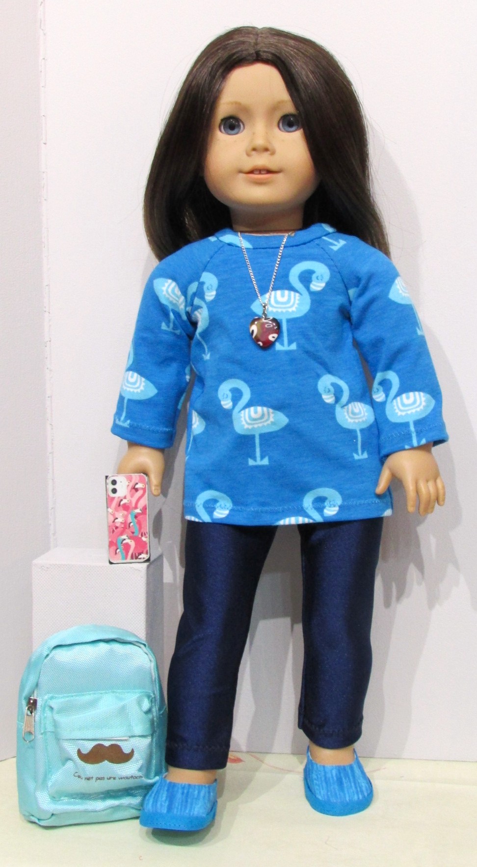 832   Flamingo top, navy blue leggings, shoes, necklace, mobile phone & rucksack