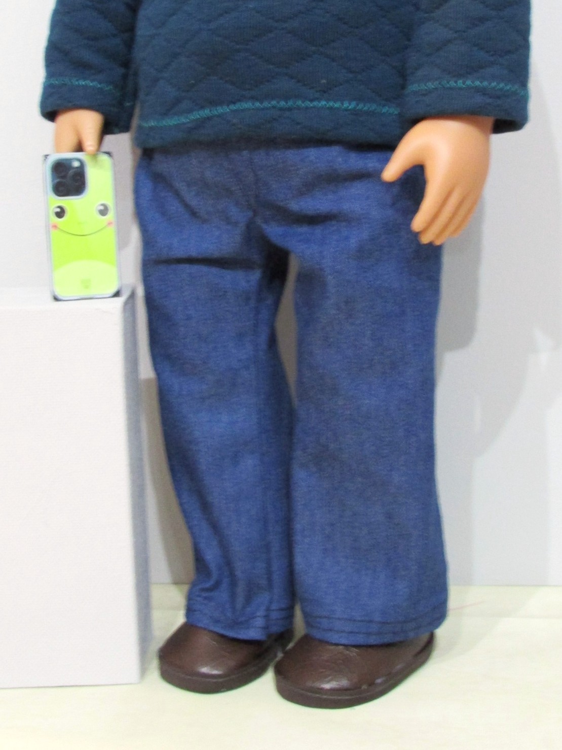 842    Deep Petrol Top, Knitted Hat, Blue Jeans, Brown Shoes and Mobile Phone