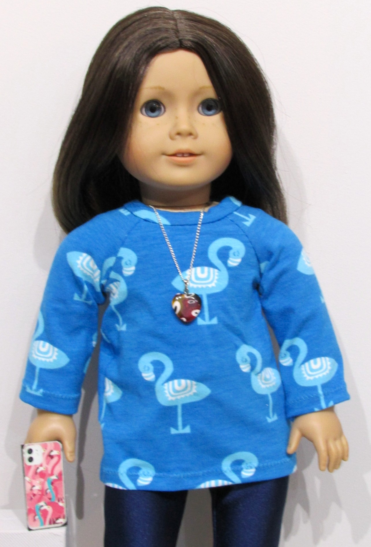 832   Flamingo top, navy blue leggings, shoes, necklace, mobile phone & rucksack