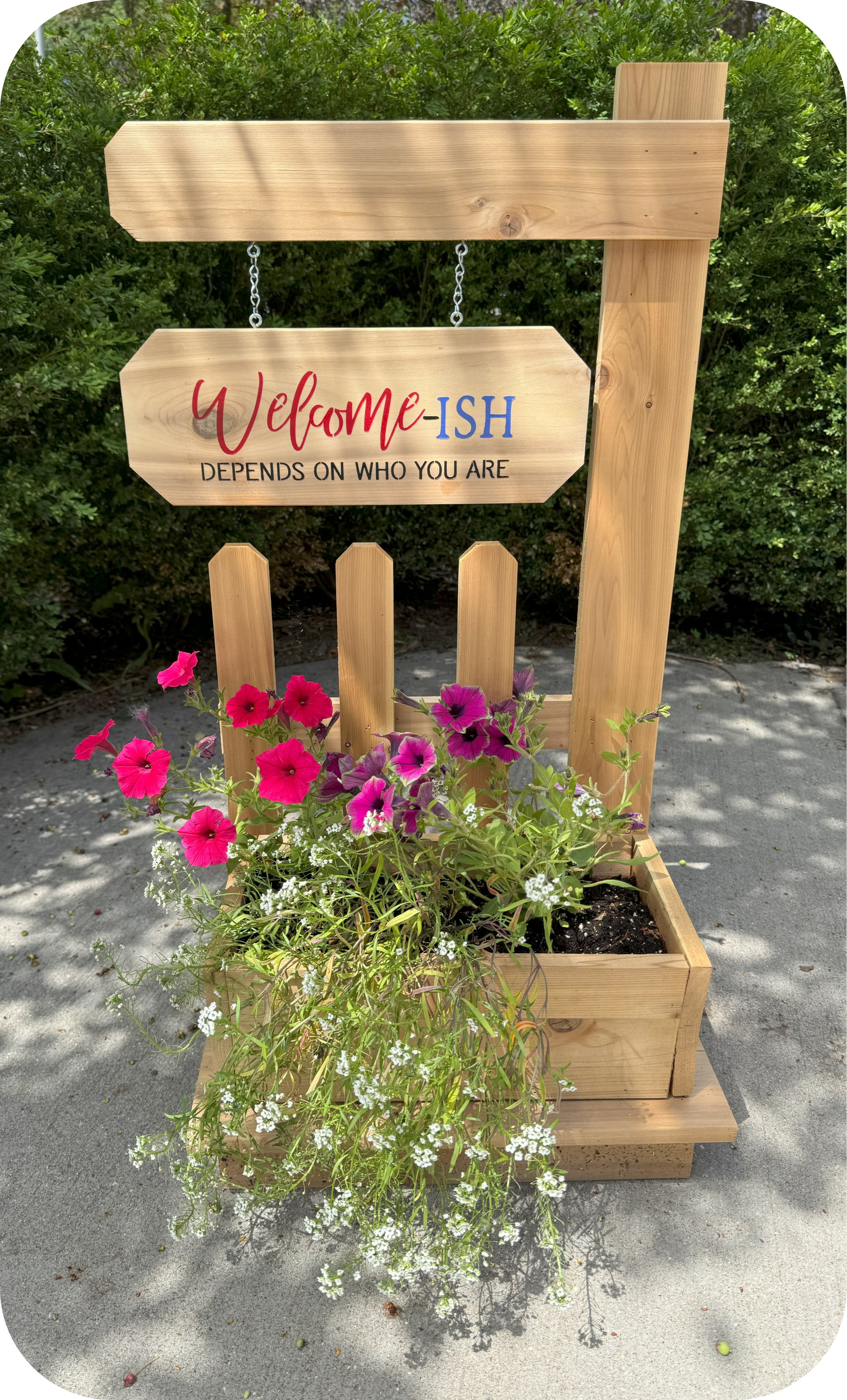 Picket fence hanging welcome sign with planter stand