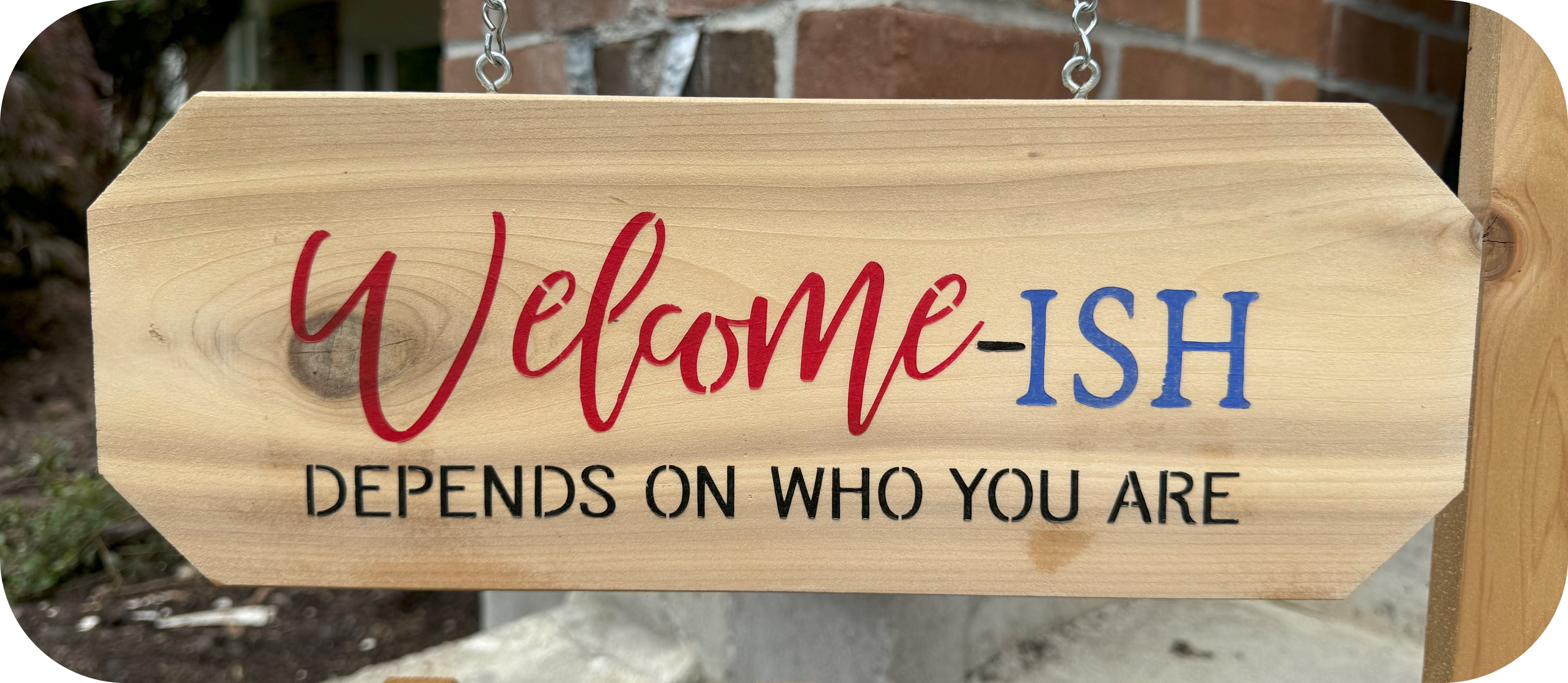 Picket fence hanging welcome sign with planter stand