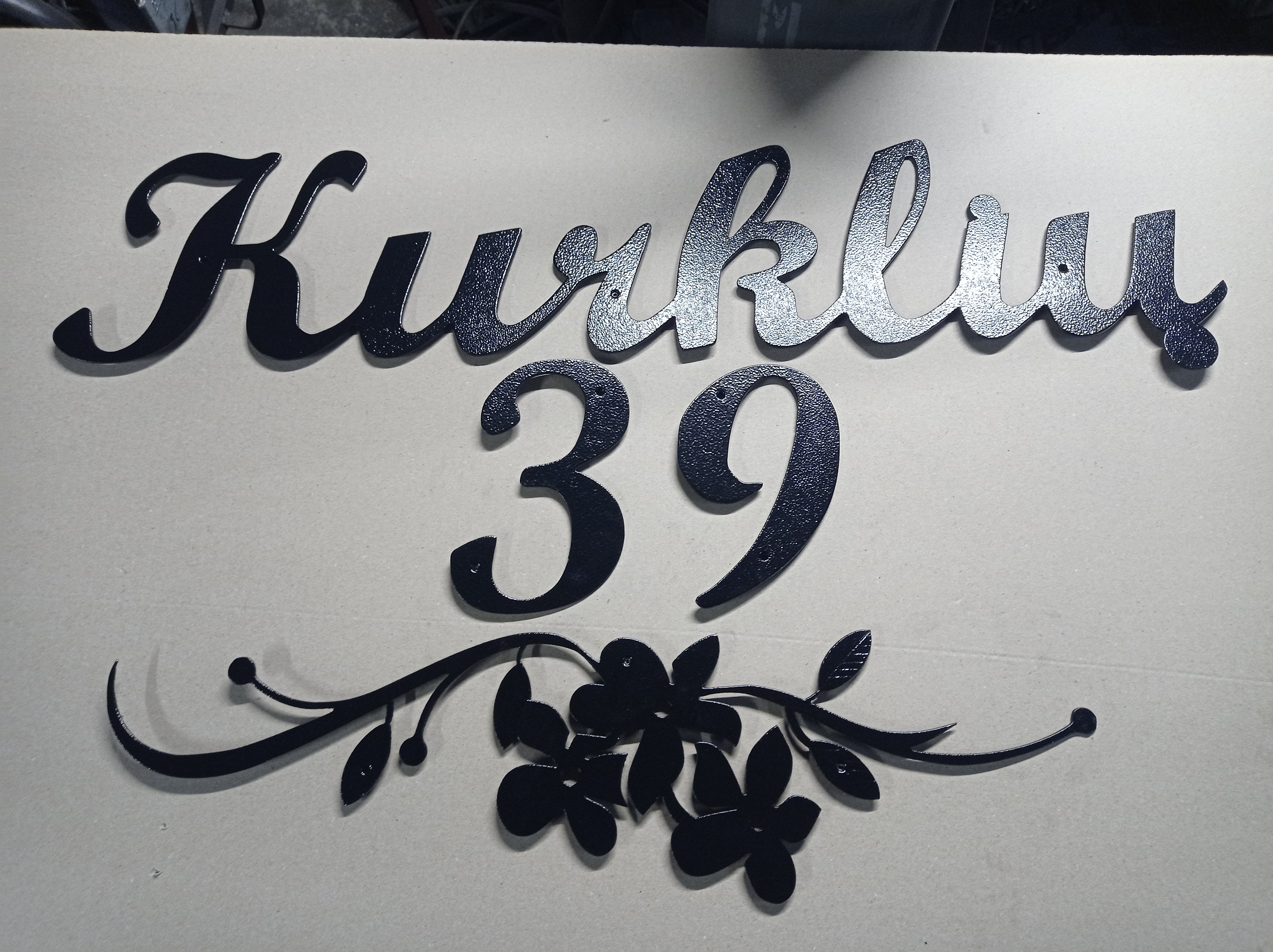 Gatvės užrašas su gėlės dekoracija