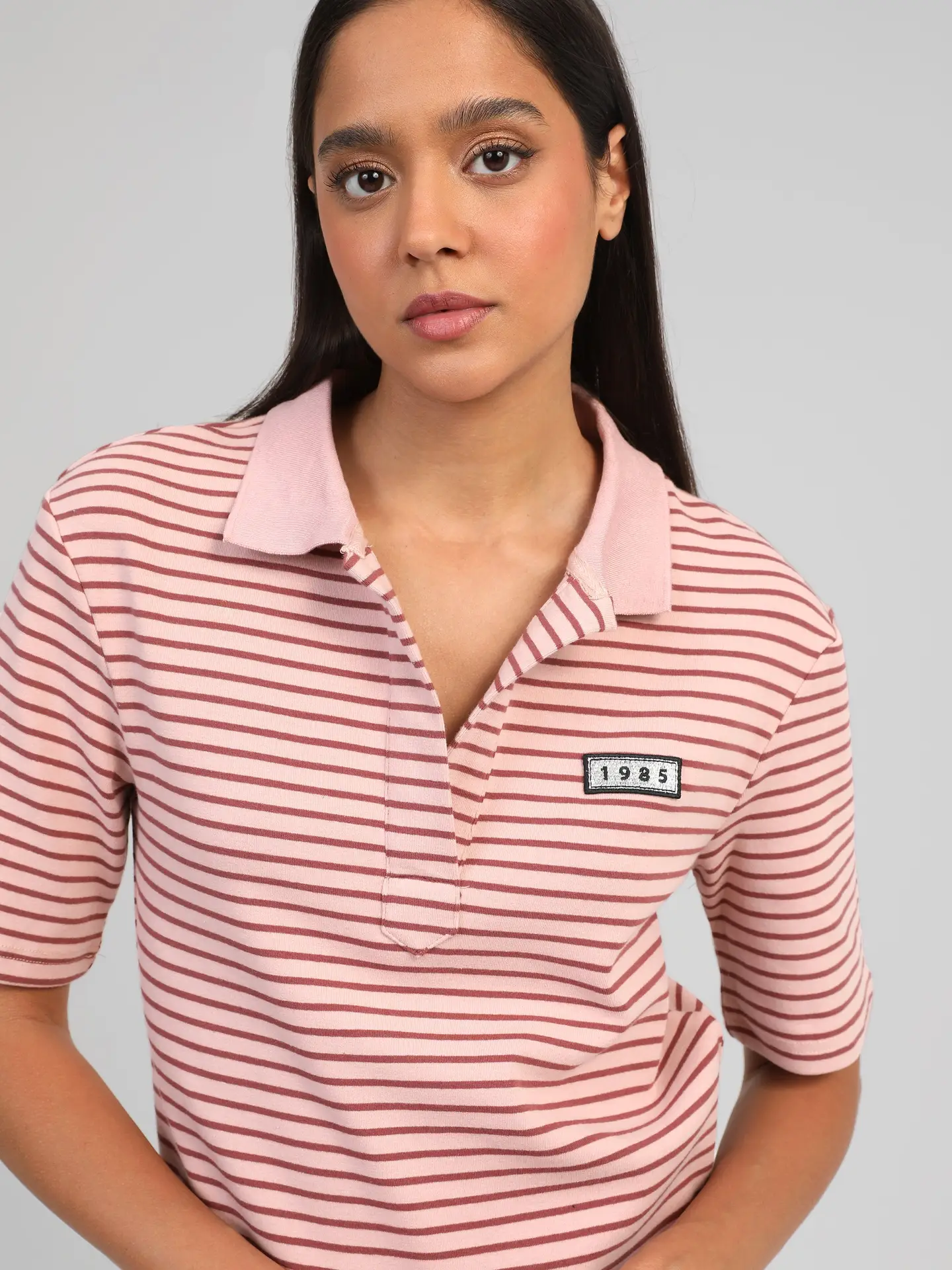 Le t-shirt col polo rayé rouge fond rose pour un style glamout