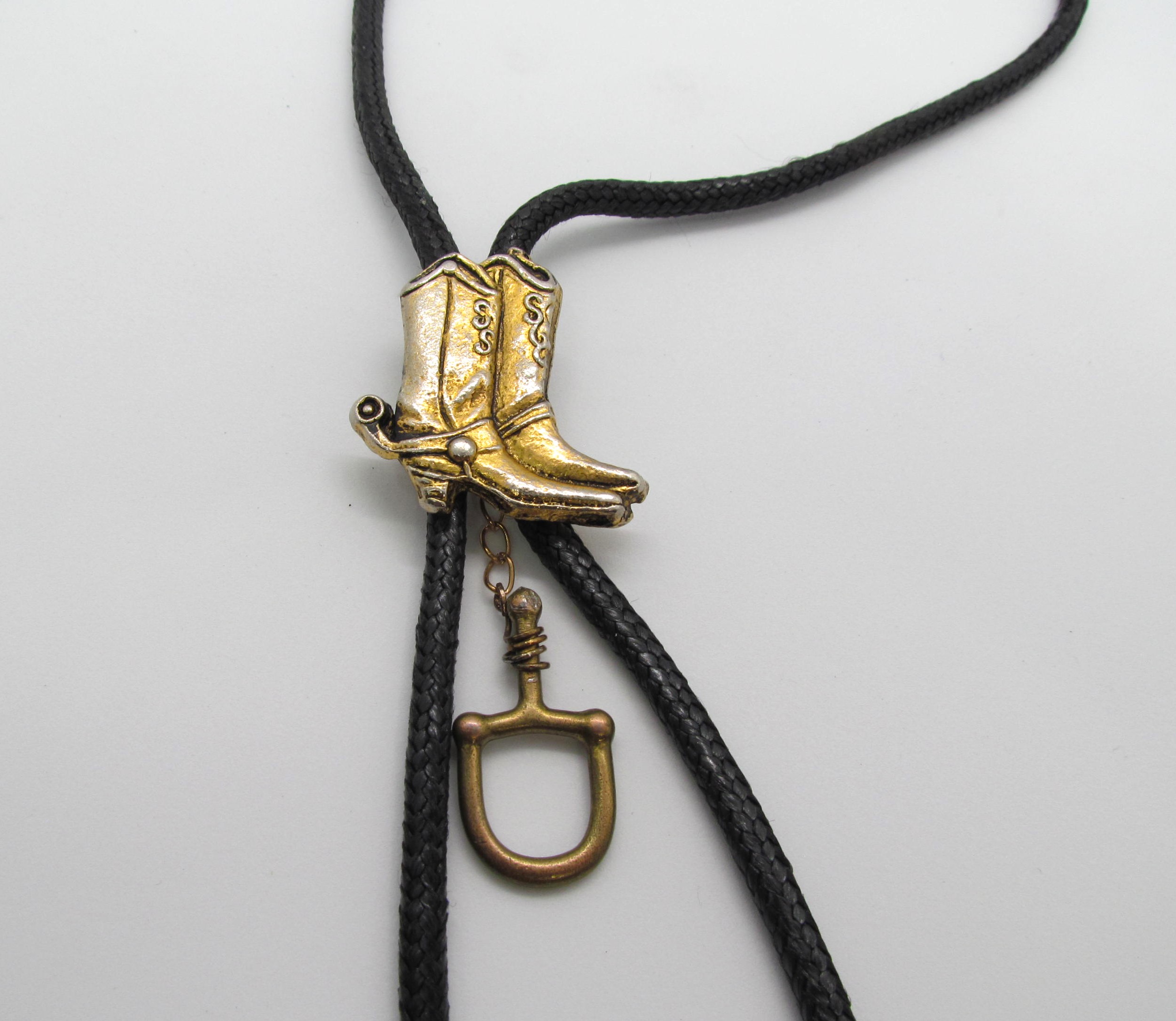 Handcrafted Cowboy Boots & Stirrup Leather Bola Tie.