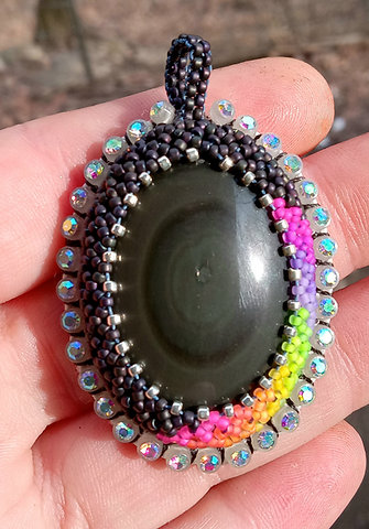 Glow in the dark blacklight reactive dark rainbow obsidian beaded pendant