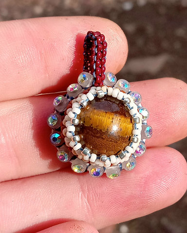 Glow in the dark beaded tigers eye pendant