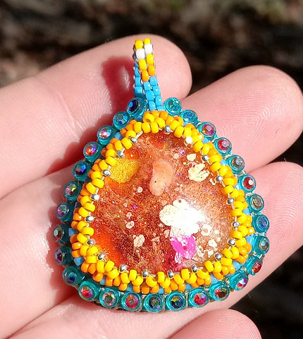 Orange and teal beaded pendant