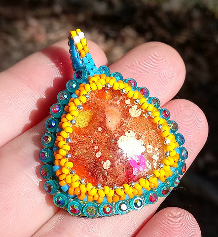Orange and teal beaded pendant