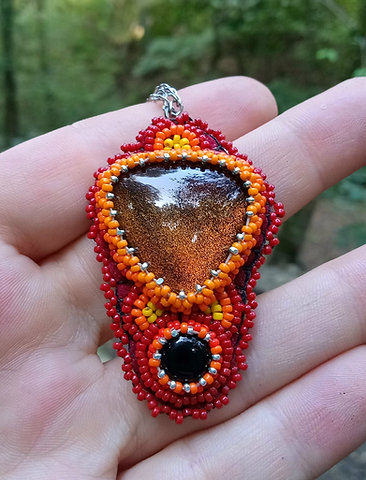 Firey bead embroidered glass and onyx pendant