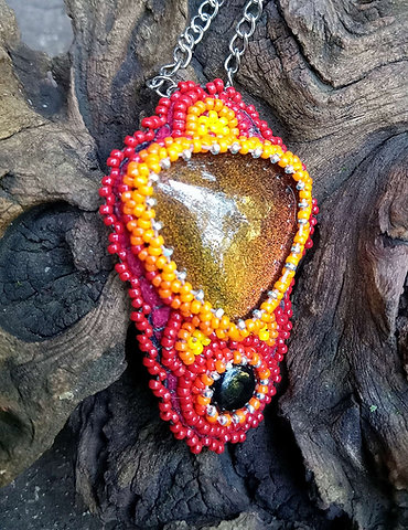 Firey bead embroidered glass and onyx pendant