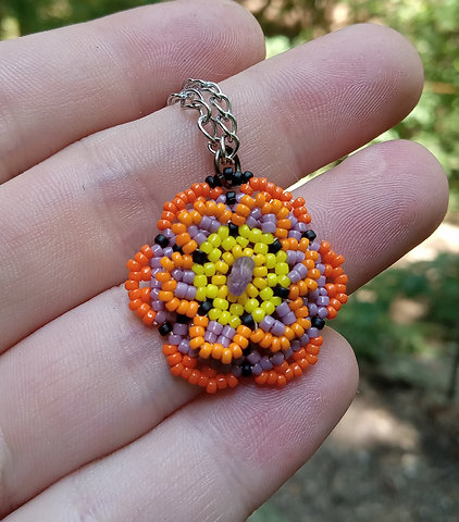 Purple and orange beaded flower pendant with amethyst