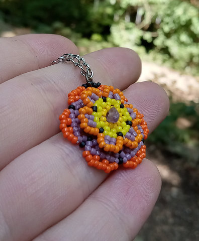 Purple and orange beaded flower pendant with amethyst