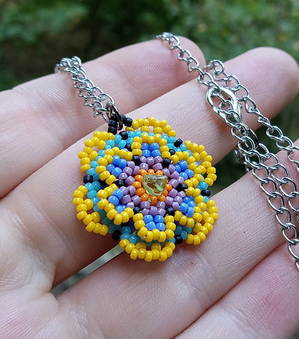 Beaded flower pendant with peridot