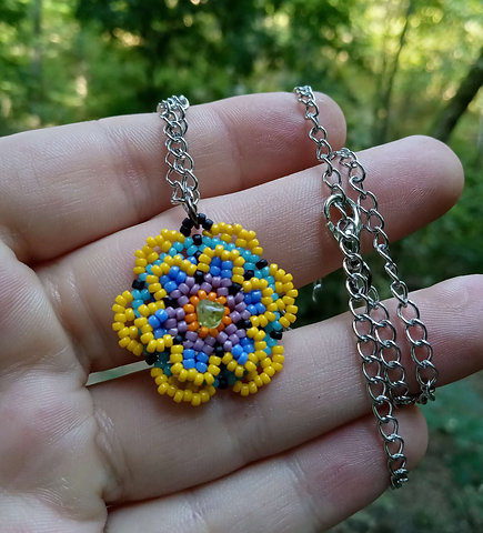 Beaded flower pendant with peridot