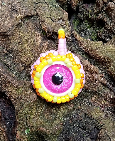 Pink eyeball with pink and yellow beadwork