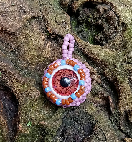 Brown eyeball with creamy purple beadwork