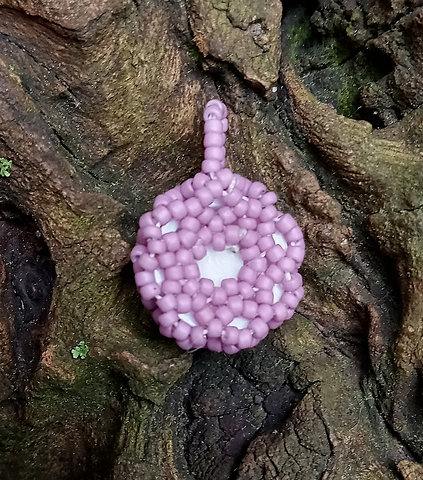 Brown eyeball with creamy purple beadwork