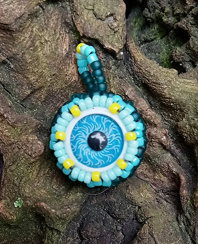Blue eyeball with dark frosty teal beadwork