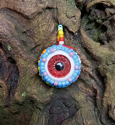 Brown eye rainbow beaded pendant