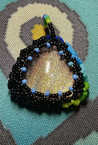 Color shifty beaded triangle pendant